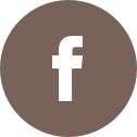 An icon of a brown circle with a white Facebook "F" logo in the center. 