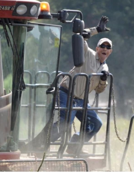 Man waving while on tractor